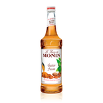 a glass bottle of Monin Butter Pecan syrup a white cap and white label with a spoon of butter dripping over pecans on the label
