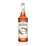 a bright goldish brown color syrup in a glass bottle with caramel candies on the white label. 