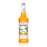 the mango syrup in the glass bottle is a bright orangish-yellow color, mango on the label with mango branches in bloom