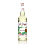 a almost clear syrup with peppermint candies and mint leaves across the label and a mocha peppermint drink off to the left side