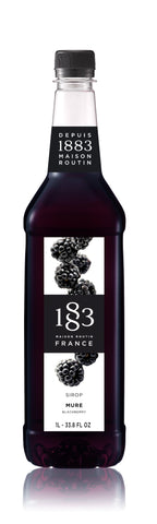 1883 Blackberry flavoring syrups has black blackberries falling down the front with a white background
