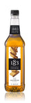 1883 Gingerbread syrup is a yellow color with gingerbread squares on the label