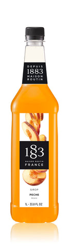 1883 Peach syrup is a bright orange color with colorfully sliced peaches on the label