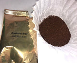 a gold foil of breakfast brew coffee with a white coffee filter filled with ground coffee