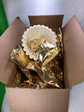 a box of gold coffee packets and a packet of coffee filters 