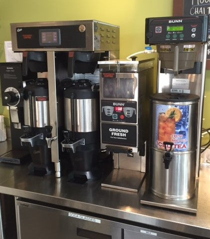 several pieces of coffee equipment including a Curits brewer, bunn grinder, bunn iced tea machine