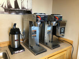 2 bunn airpot coffee brewers set up with a grinder and an airpot at a larger offices complex