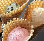 golden brown vanilla waffle cones with a scoop of green mint and vanilla ice cream