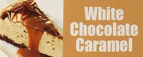 a creamy piece of white chocolate cheese cake with swirled chocolate on the top and drenched with caramel